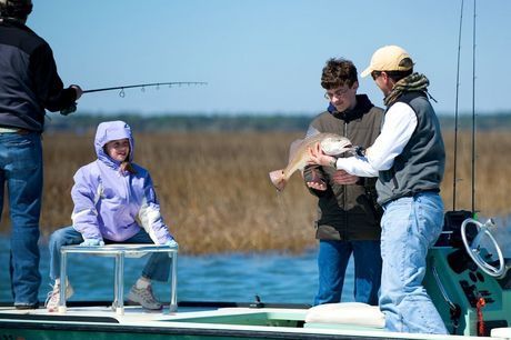 Admiring a big red drum (spot-tailed bass)