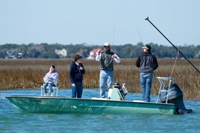Capt. Legare teaches a boy how to cast his line
